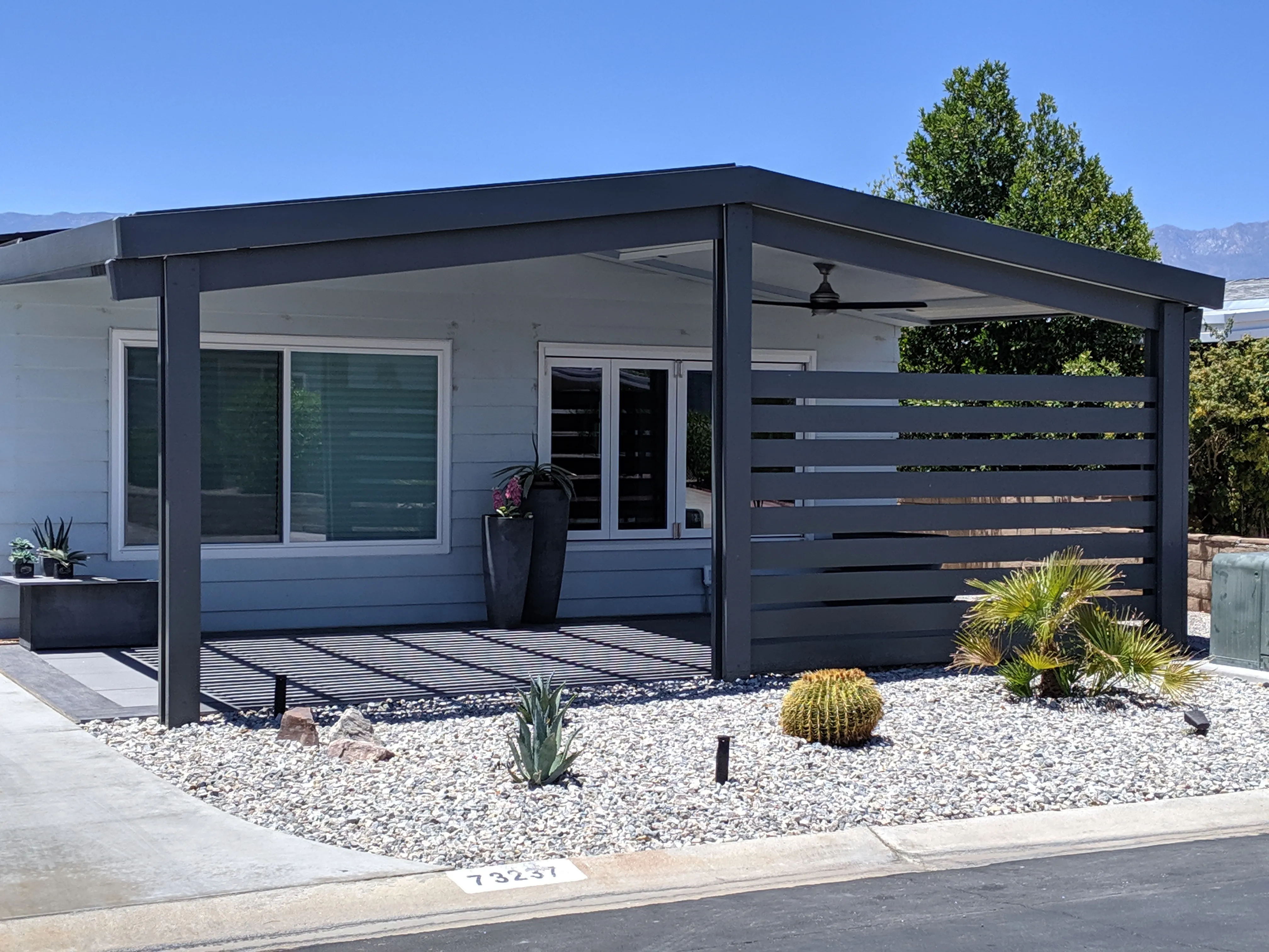 Weatherwood insulated patio cover with privacy wall for a backyard