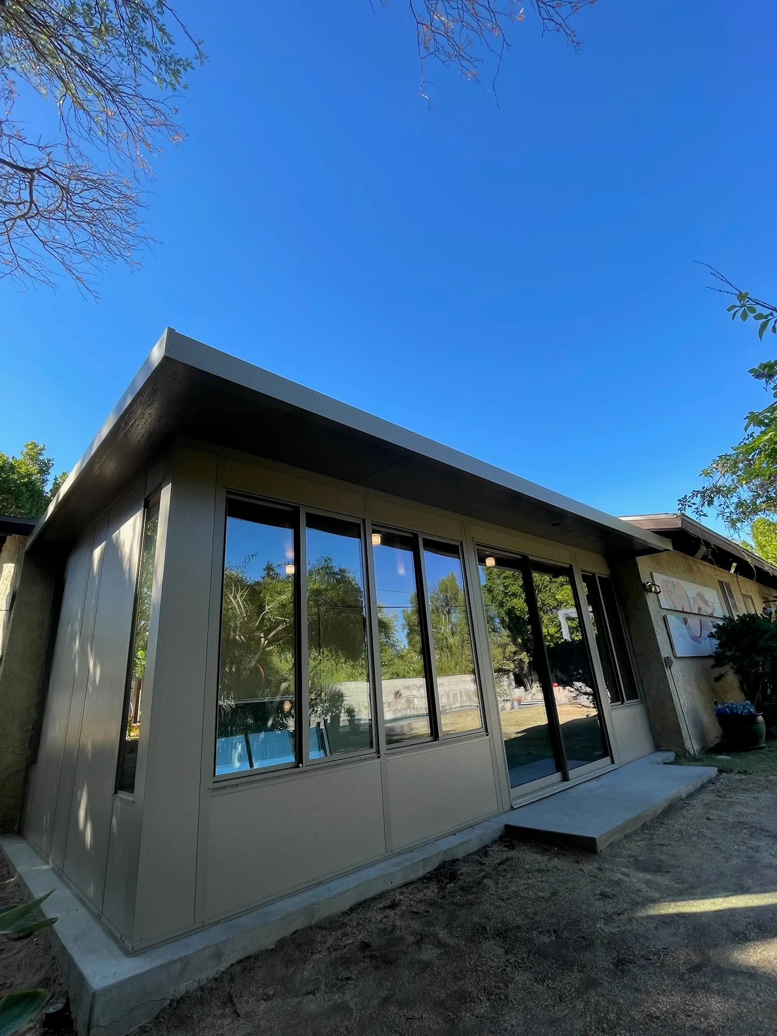 Duralife room enclosure in driftwood finish for a covered outdoor space